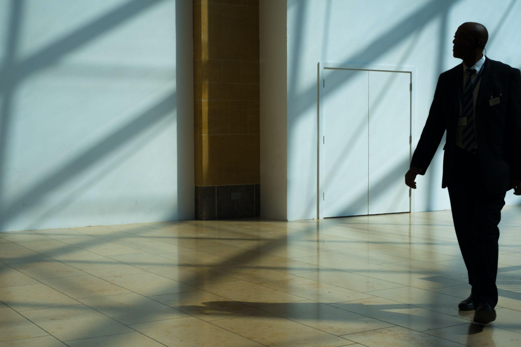 A security service employee checking a bank's building