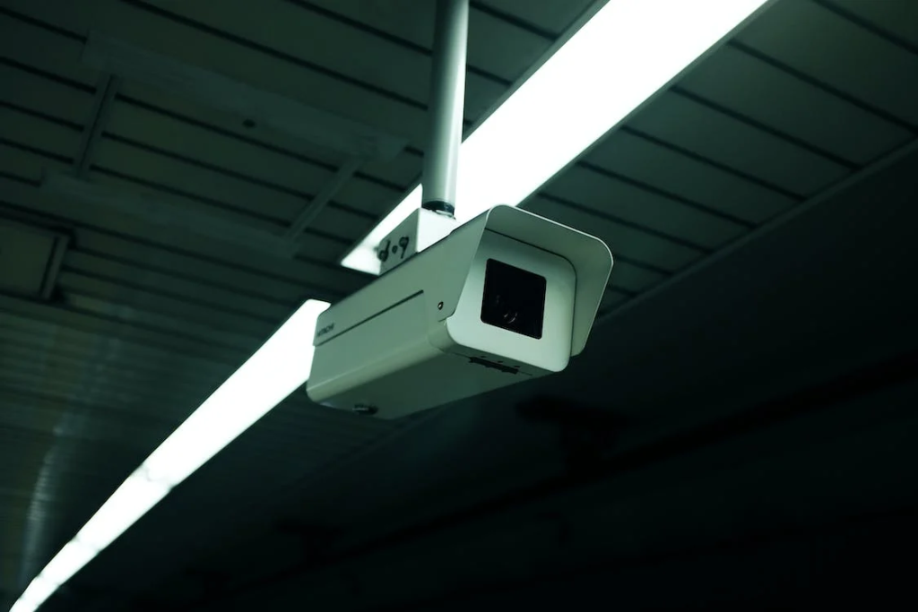 A blurry image of a camera hanging from a ceiling.
