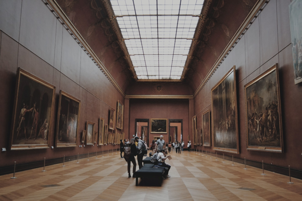A large room with many paintings on the walls.