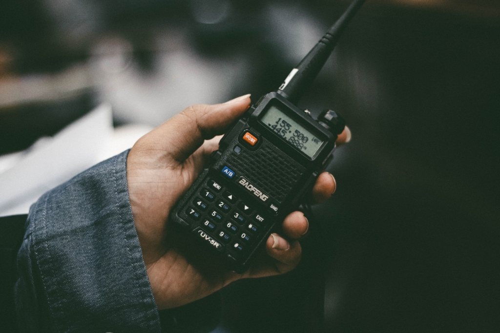 A person holding a cell phone in their hand.