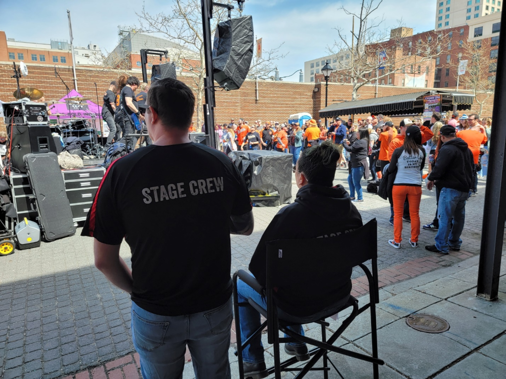 A crowd of people are gathered around a stage.