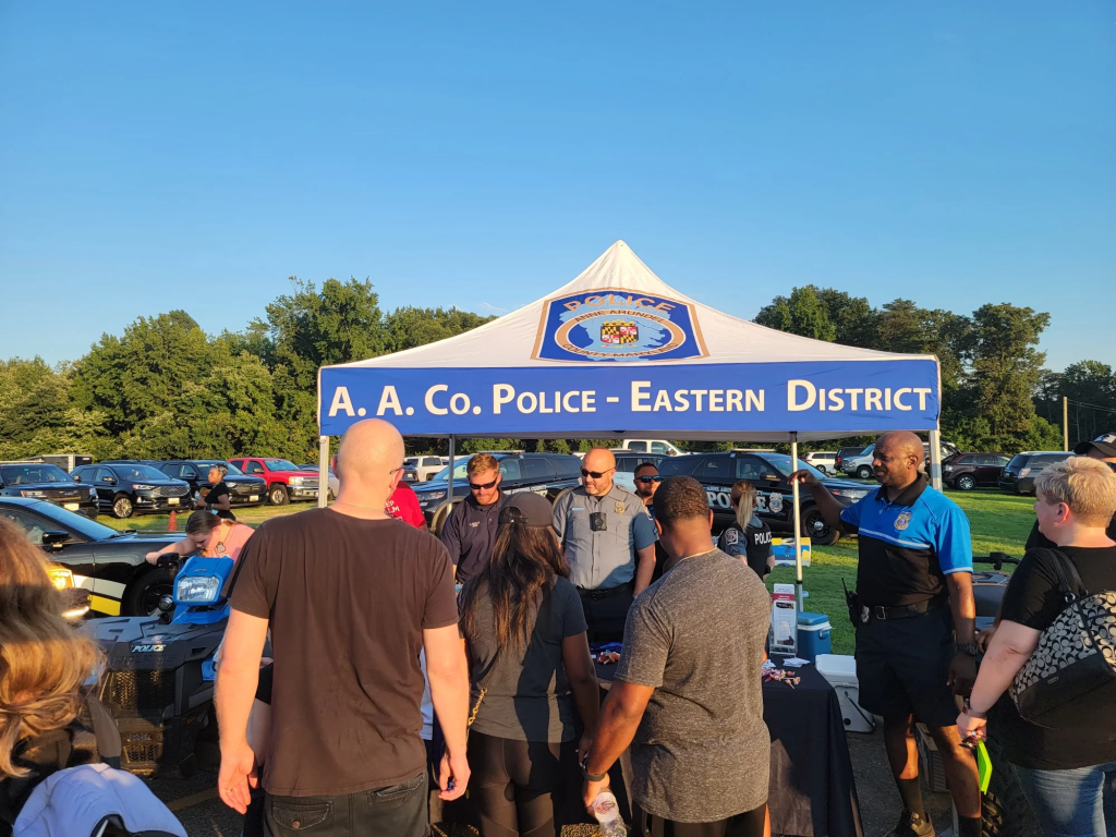 Armed security for crowd control in front of stalls at an event