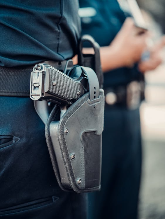An image of a person with a gun strapped to their belt