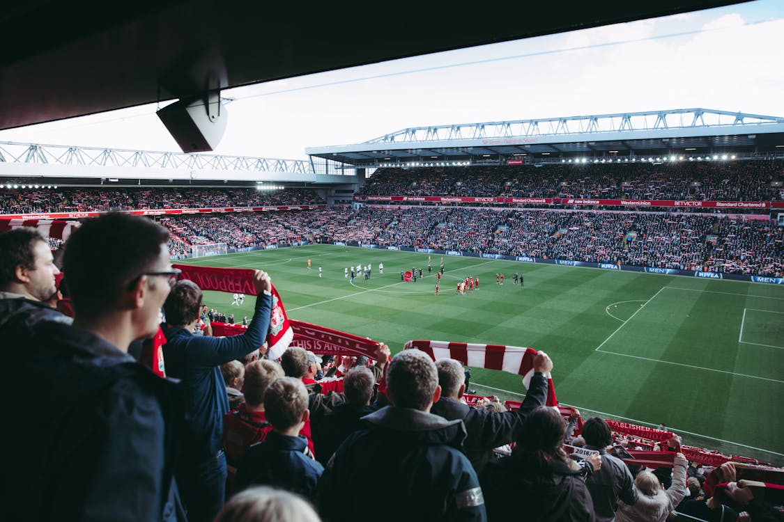 An image of people watching a match in a stadium