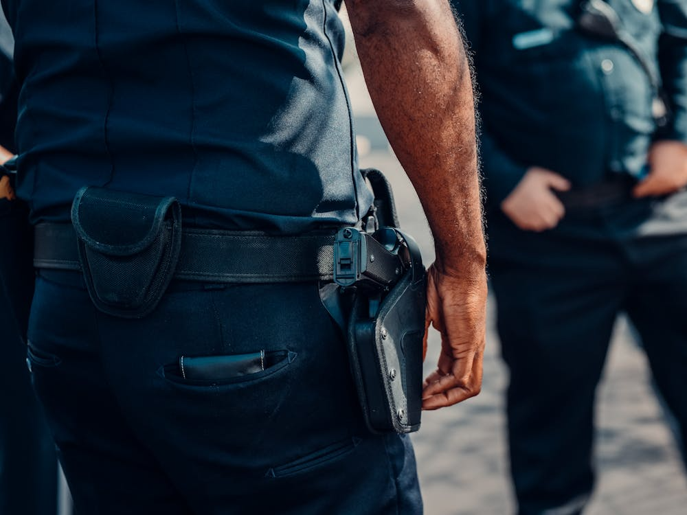An image of a person with a gun strapped to their belt