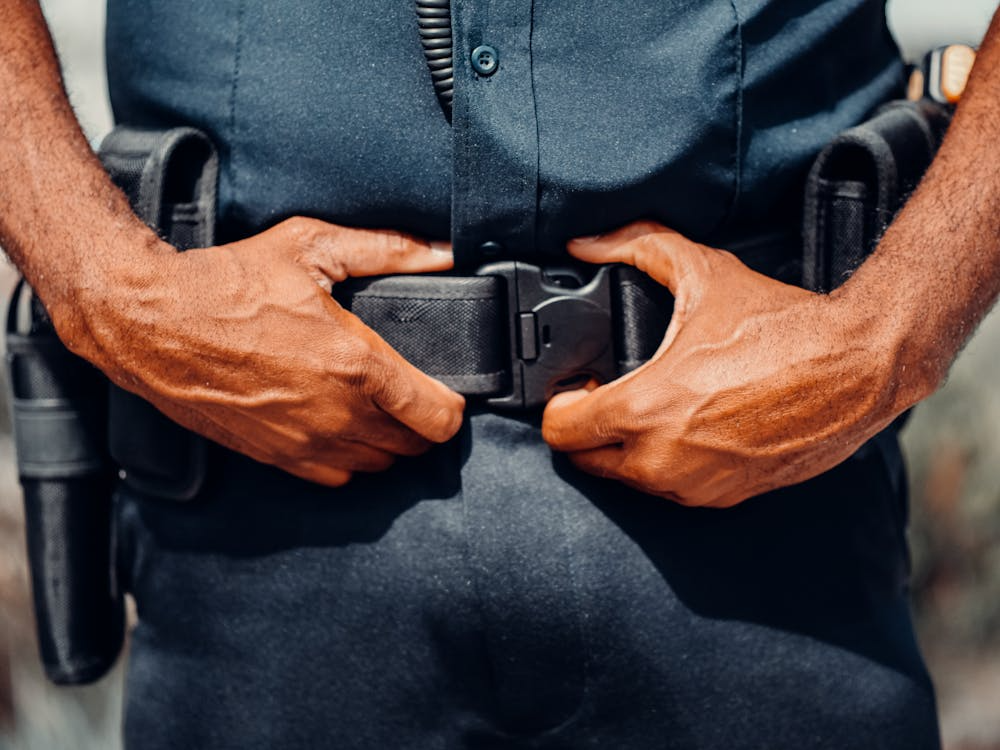 An image of a person with a gun strapped to their belt