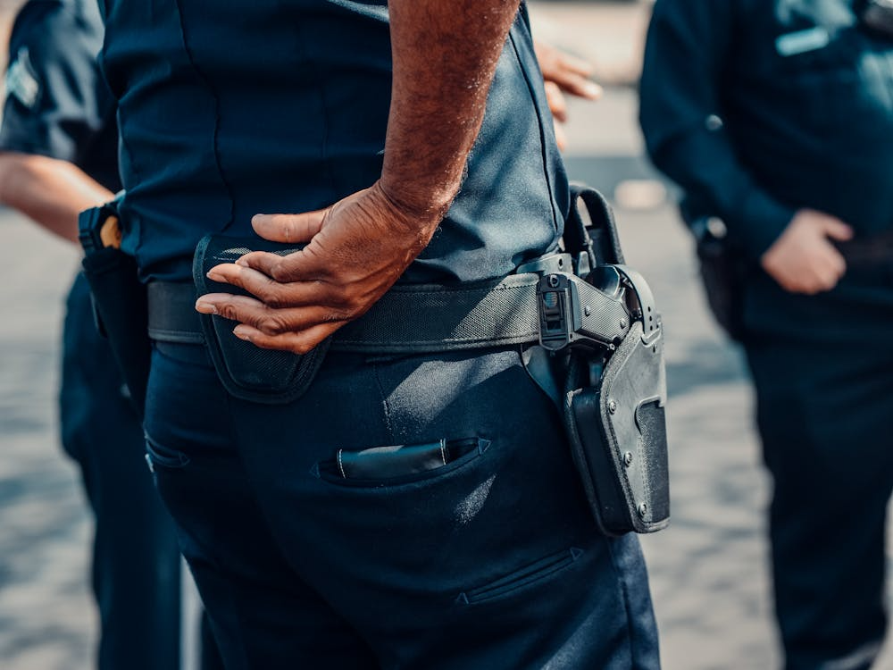 An image of a person with a gun strapped to their belt