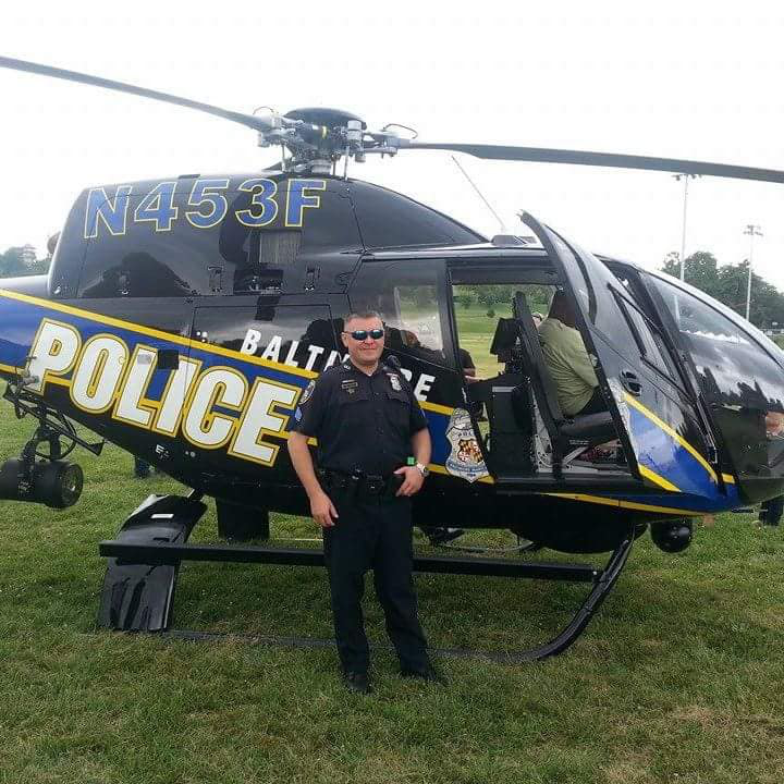 A security officer standing next to a helicopter