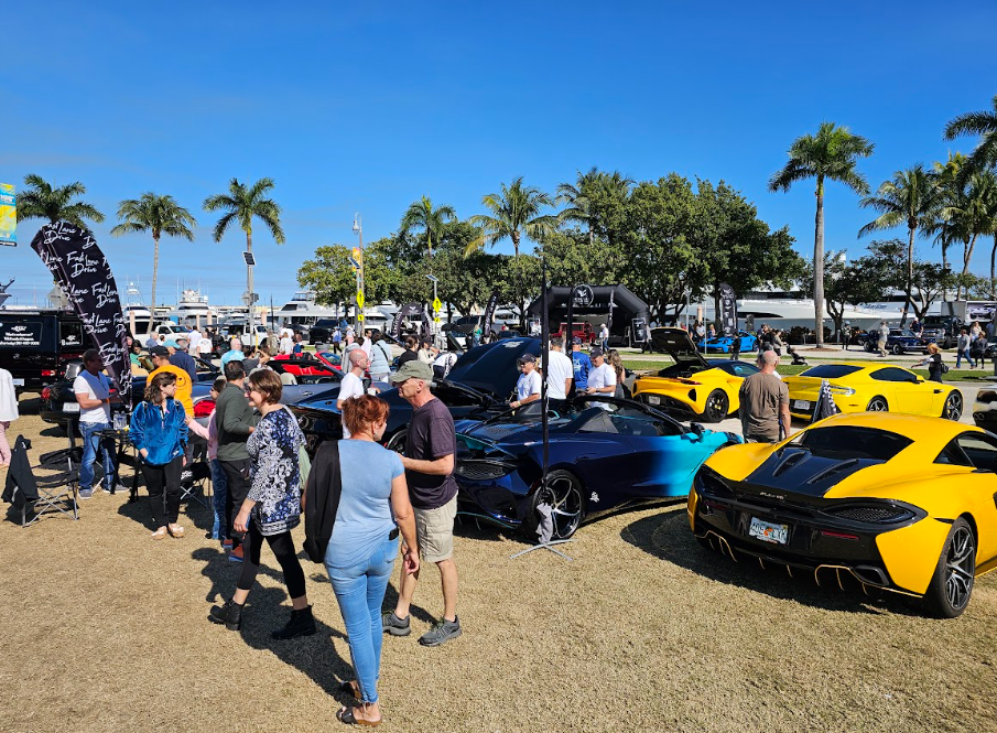This photo shows people walking casually along a car exhibition.