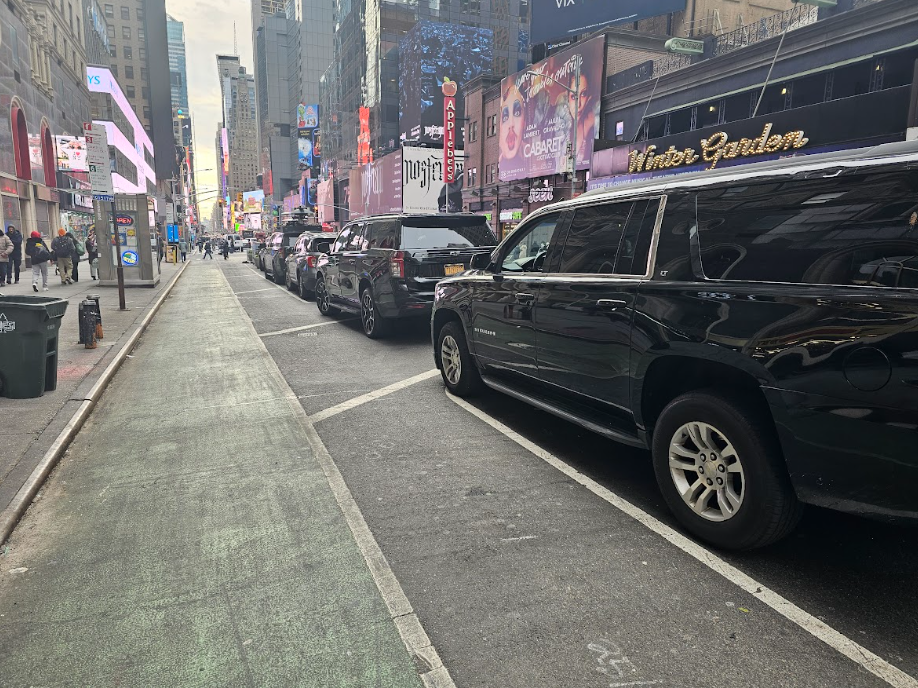 A city street with cars parked on the side of it.