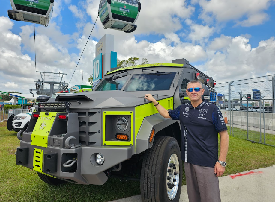 This photo shows a professional standing outside a truck.
