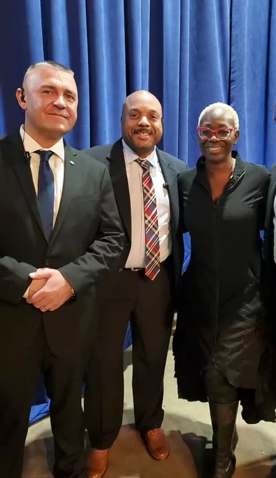 A group of men and women in suits and ties.