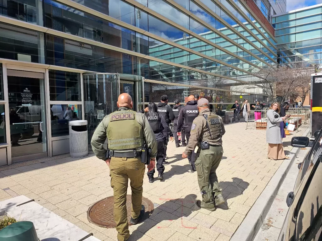 A group of police officers walking down a street.