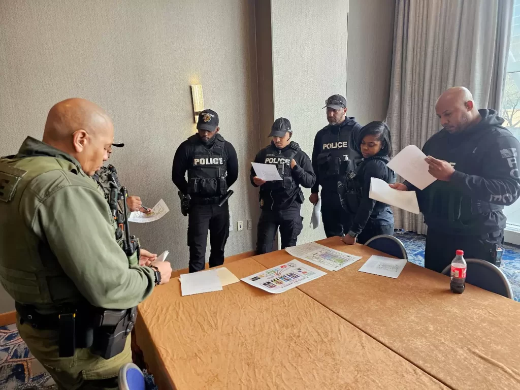 A group of police officers are gathered around a table.