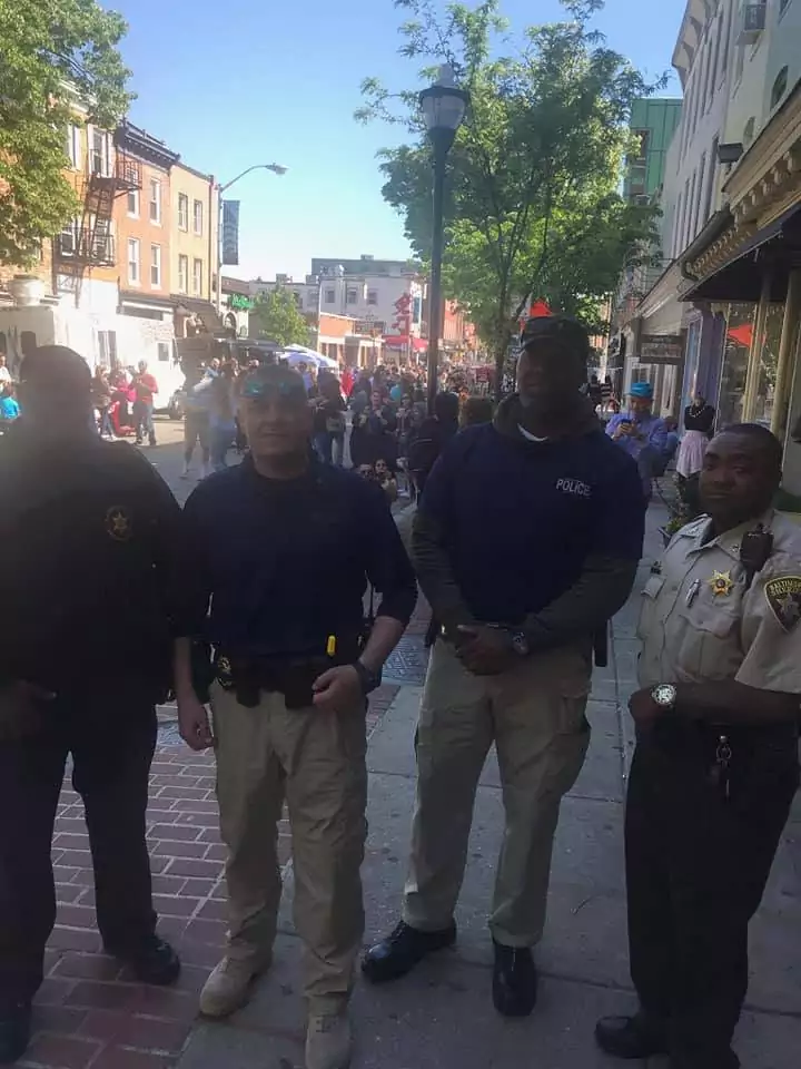 A group of police officers walking down a street.