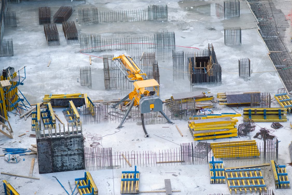 A large picture of a construction site with a crane.
