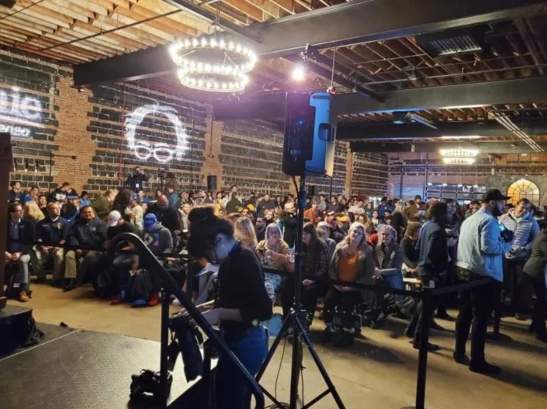 A large crowd of people in a large room.
