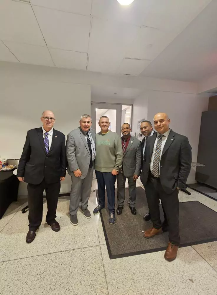 A group of men in suits posing for a photo.