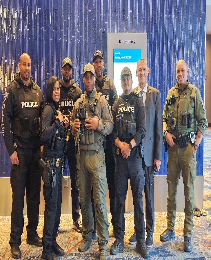 A group of people in police uniforms posing for a photo.